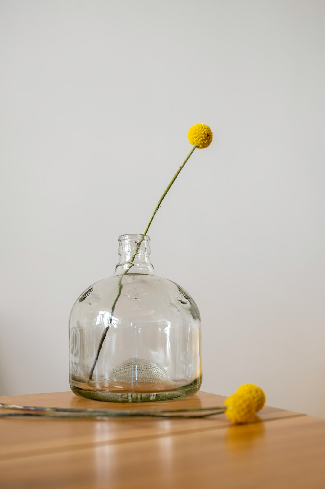 glass jar with flowers on table